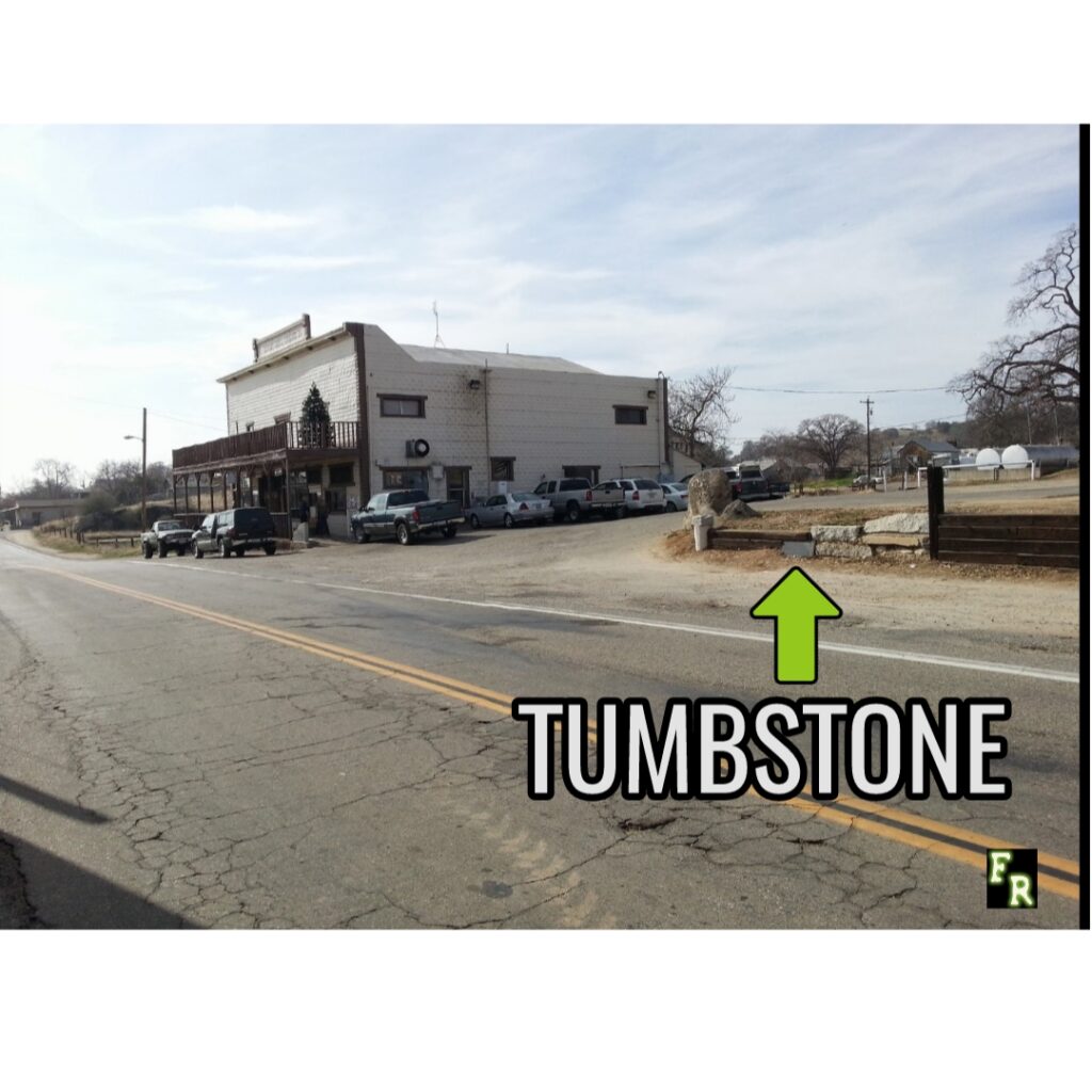 Zoomed out photo of the Raymond roadside tumbstone